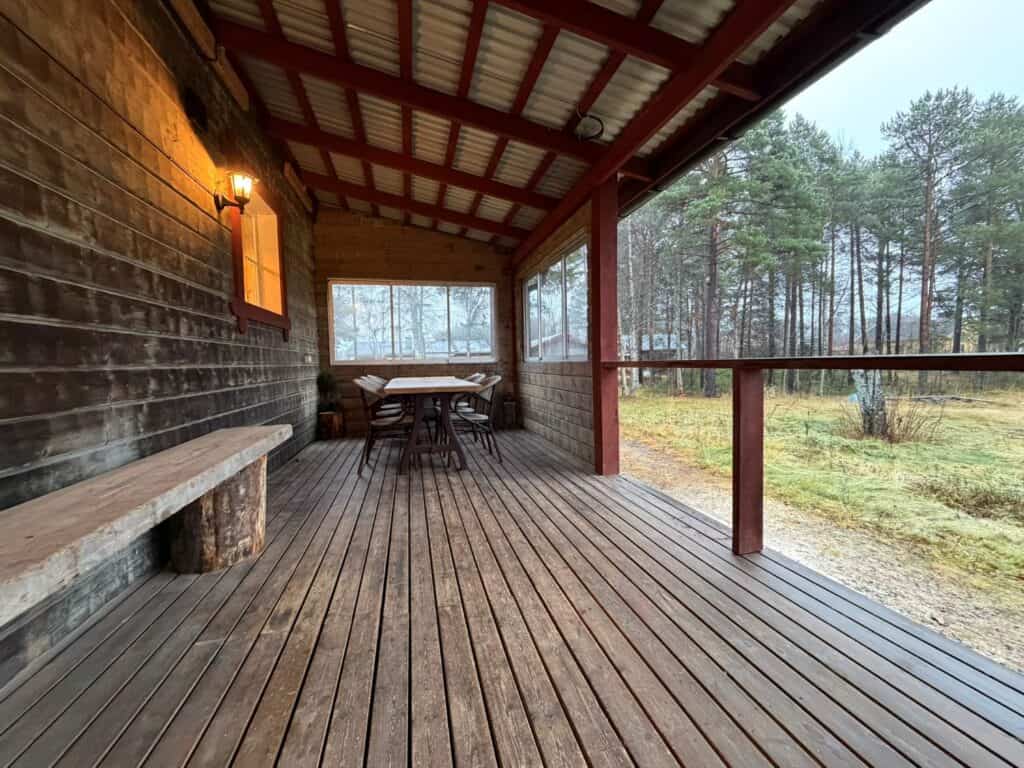 Covered outdoor terrace with dining area at Lappvall Lodge in Lapland