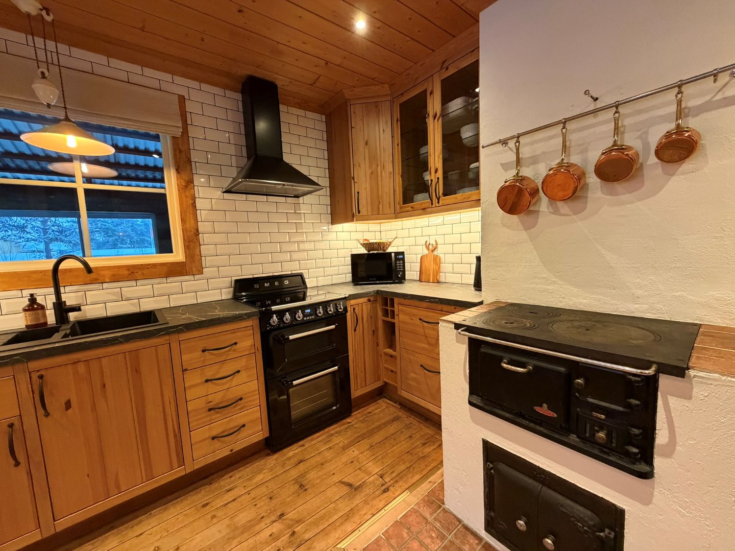 Rustic wooden kitchen with SMEG stove at Lappvall Lodge in Swedish Lapland