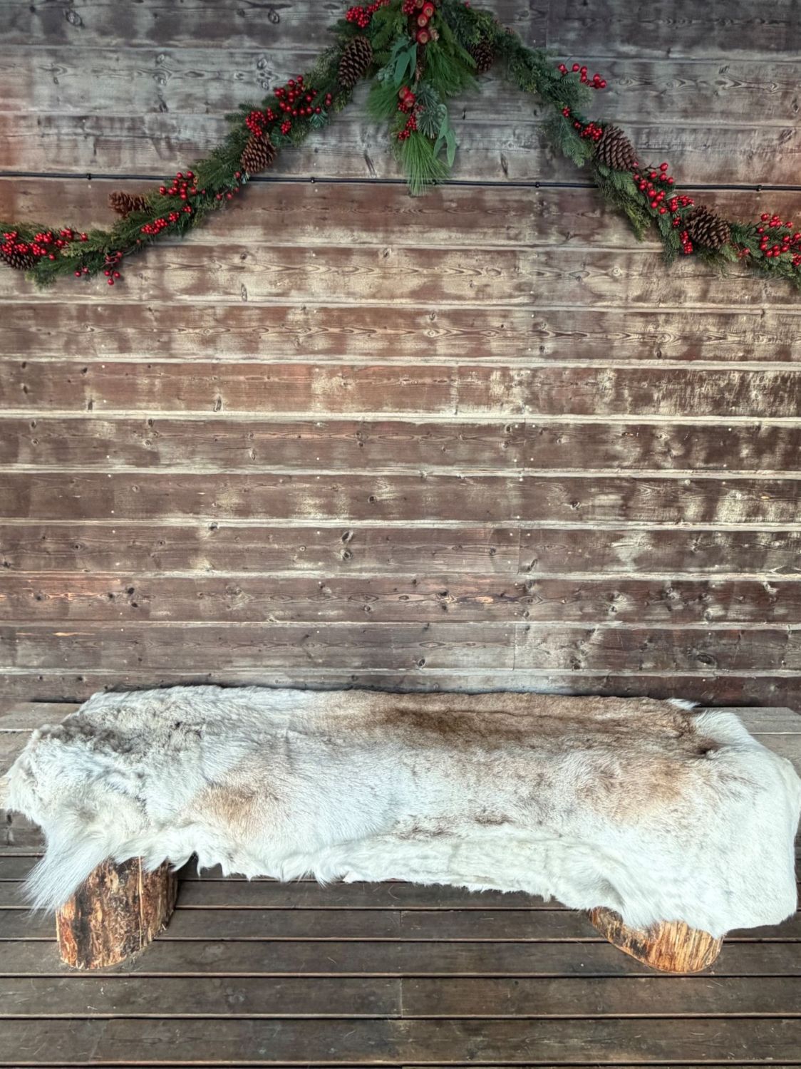 Cozy outdoor bench with reindeer skin at Lappvall Lodge