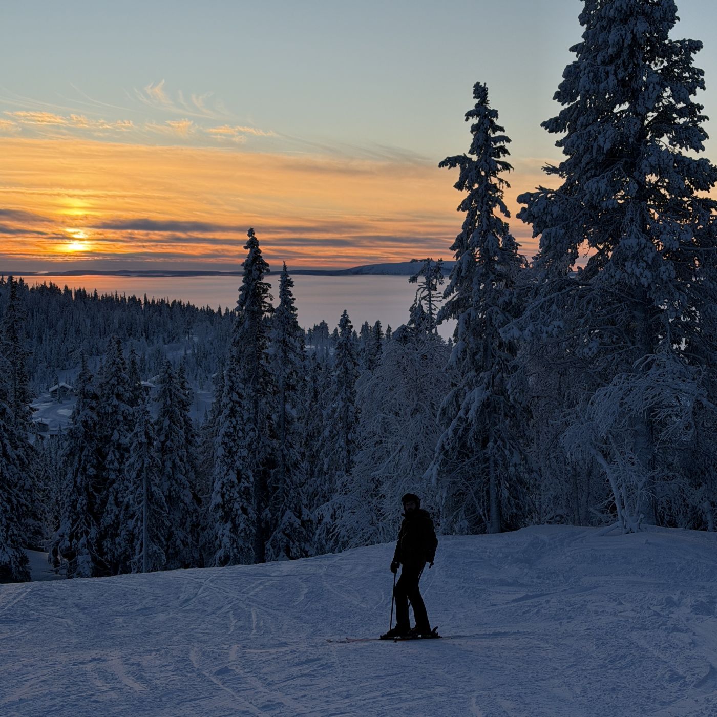 golden sunset over frozen lake Hornavan from galtis ski mountain in arjeplog, swedish lapland